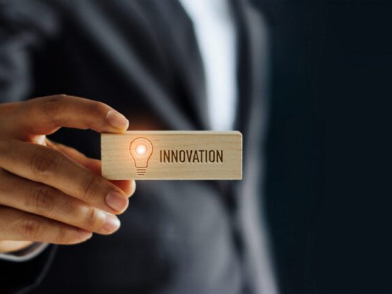 Hand of businessman holding icon lightbulb glowing and innovatio