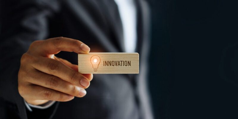 Hand of businessman holding icon lightbulb glowing and innovatio